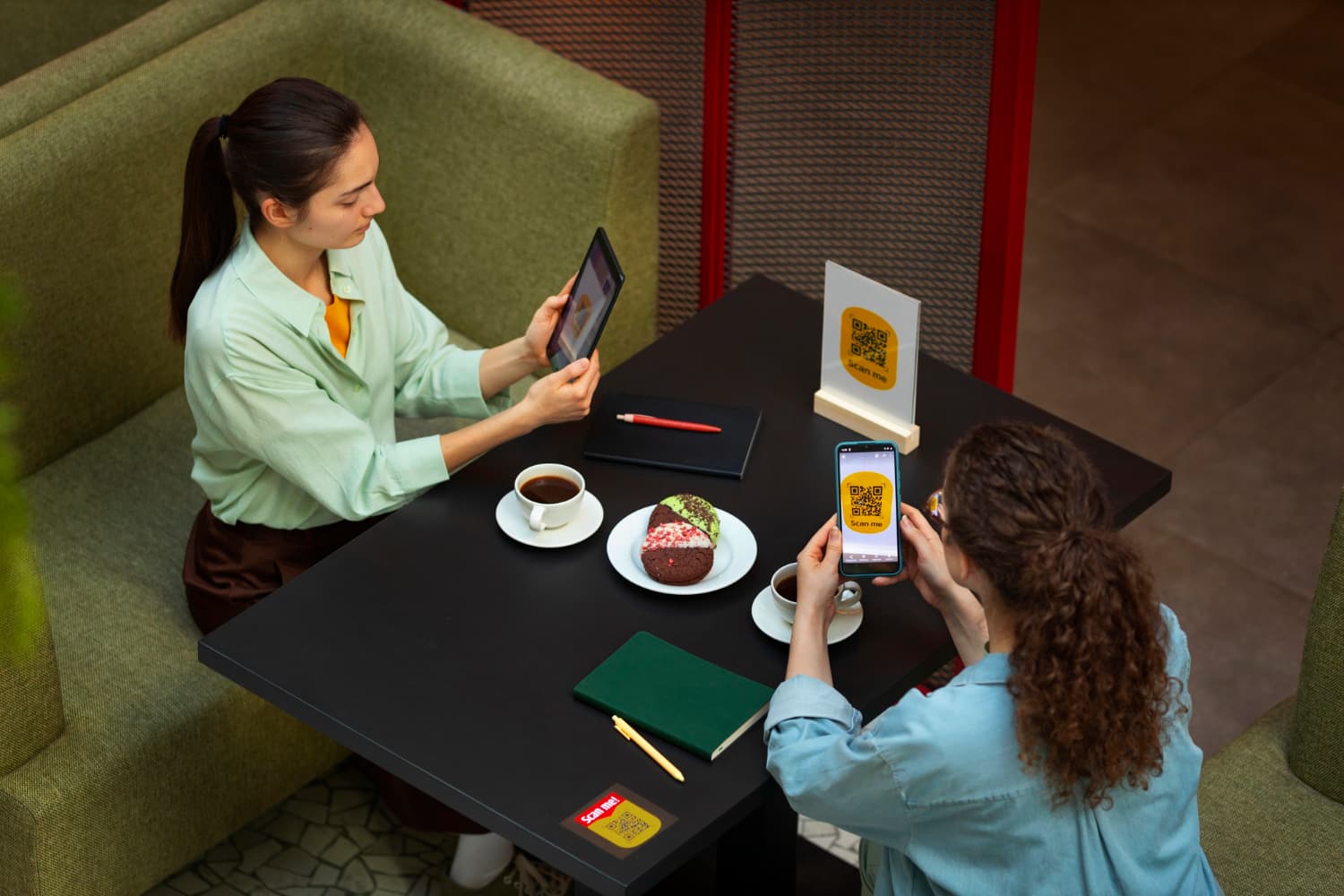 A customer scanning a QR code with their phone to order and pay